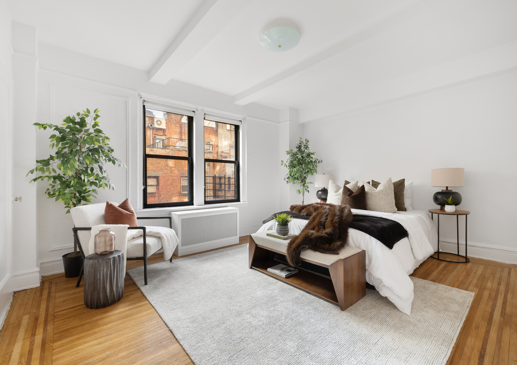 322 West 72nd Street, Unit 3D Manhattan, NY 10023 - Photo 4 of 19 a bedroom with furniture and a potted plant