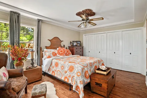 a bedroom with a bed and wooden floor