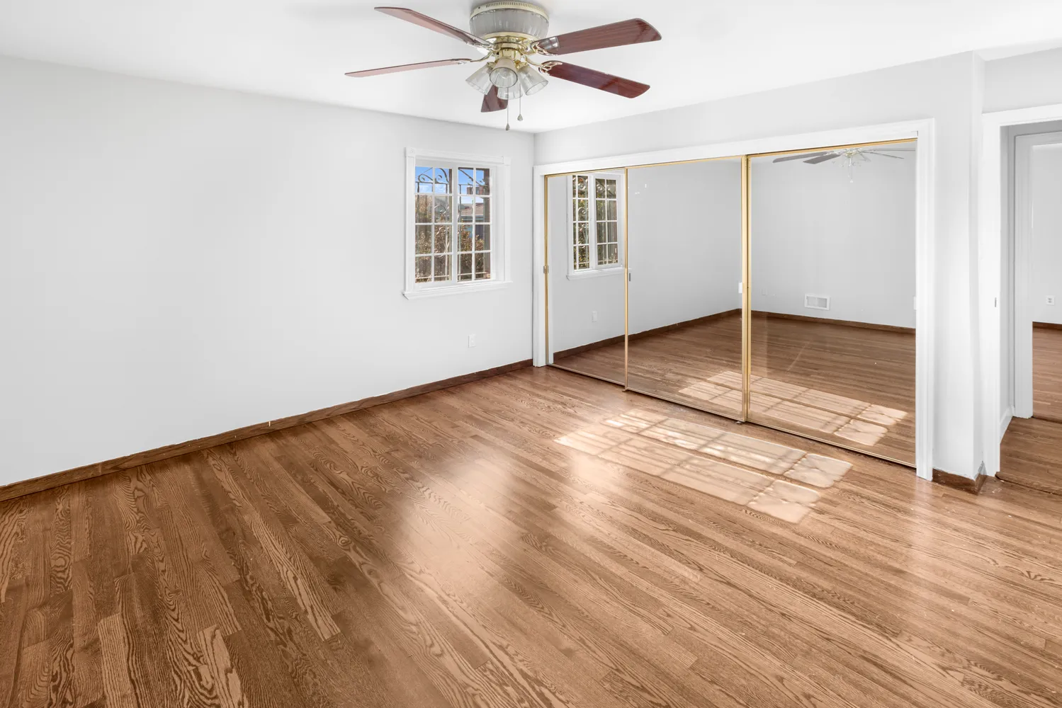wooden floor in an empty room with a window