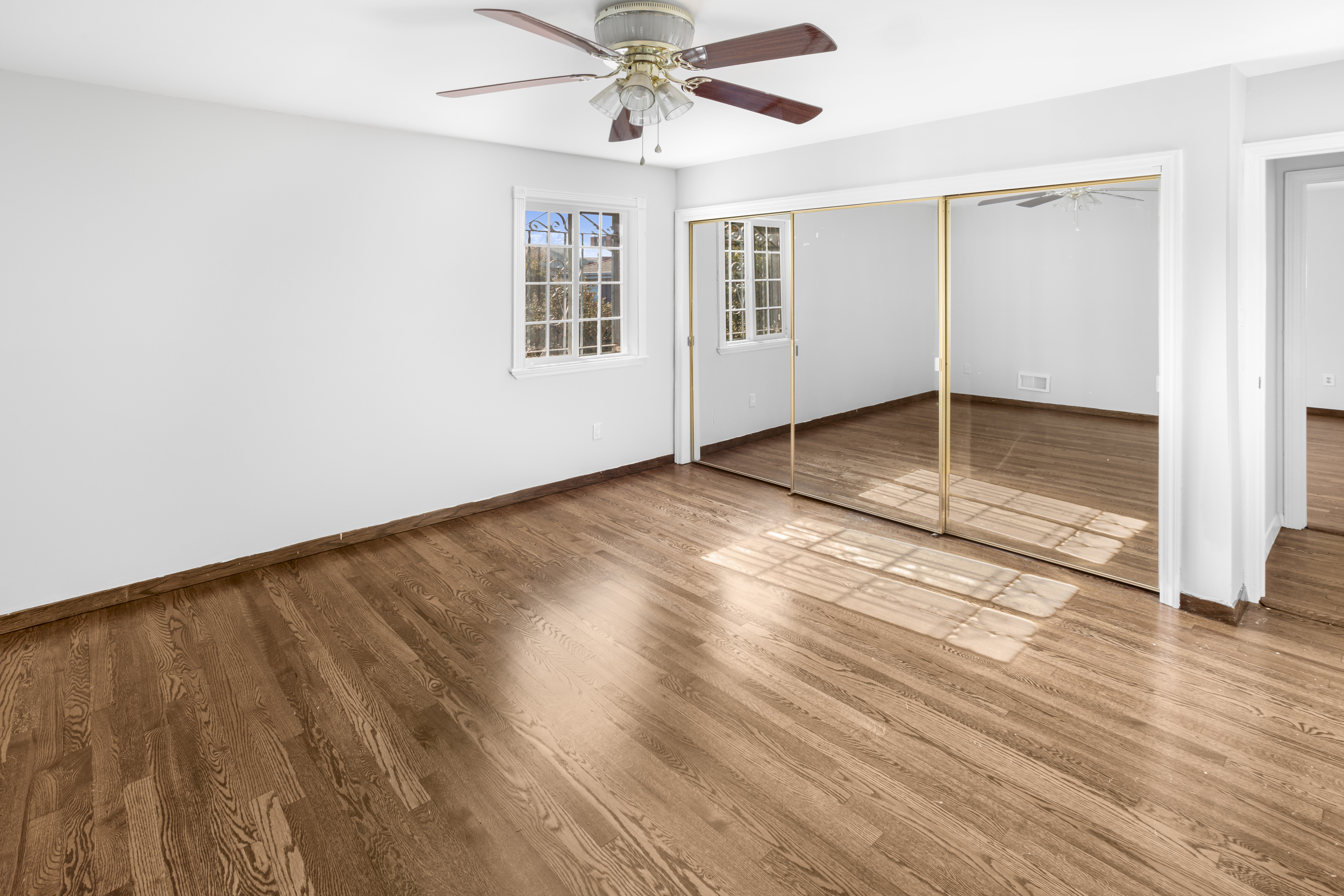 60 82nd Street Brooklyn, NY 11209 - Photo 11 of 19 wooden floor in an empty room with a window
