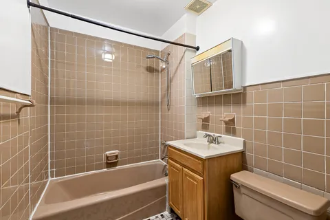 an empty room with a window and a chandelier