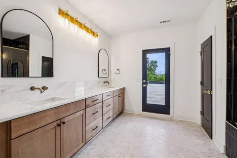 a spacious bathroom with a double vanity sink and a mirror