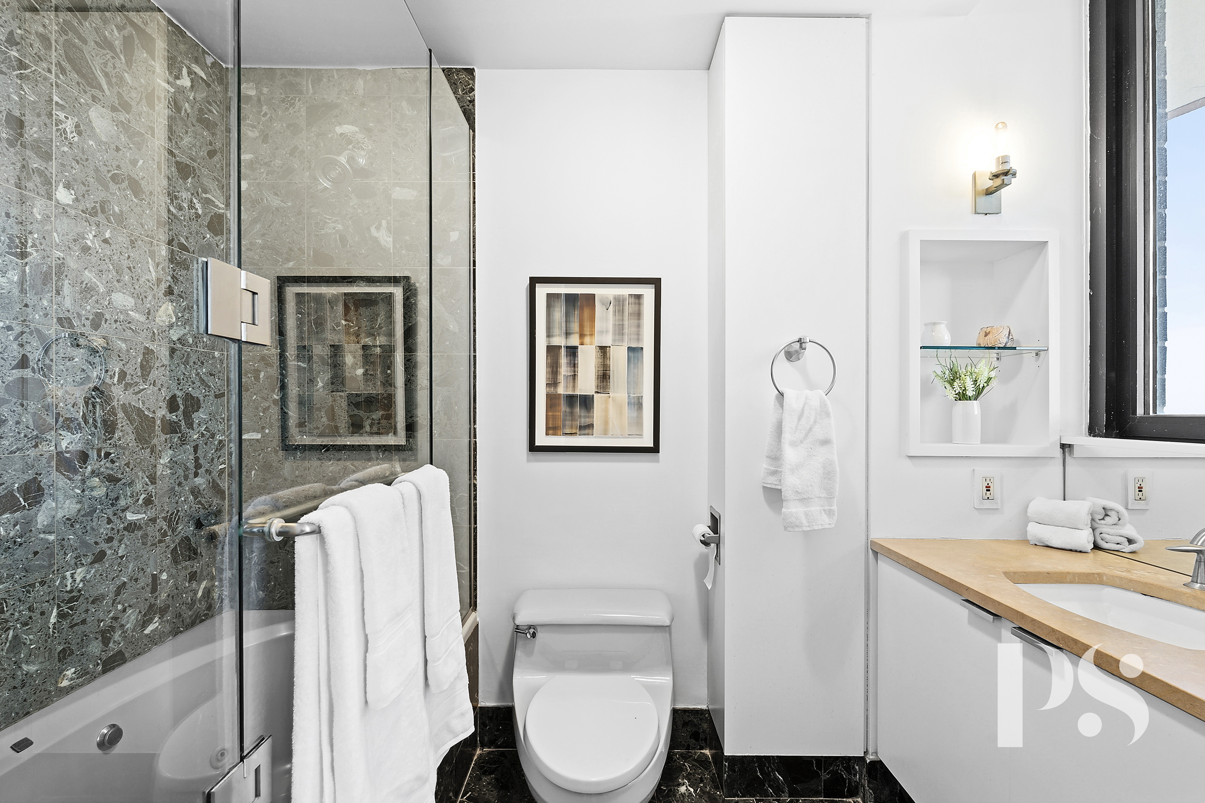 304 East 65th Street, Unit 39C Manhattan, NY 10065 - Photo 6 of 10 a bathroom with a toilet sink and shower