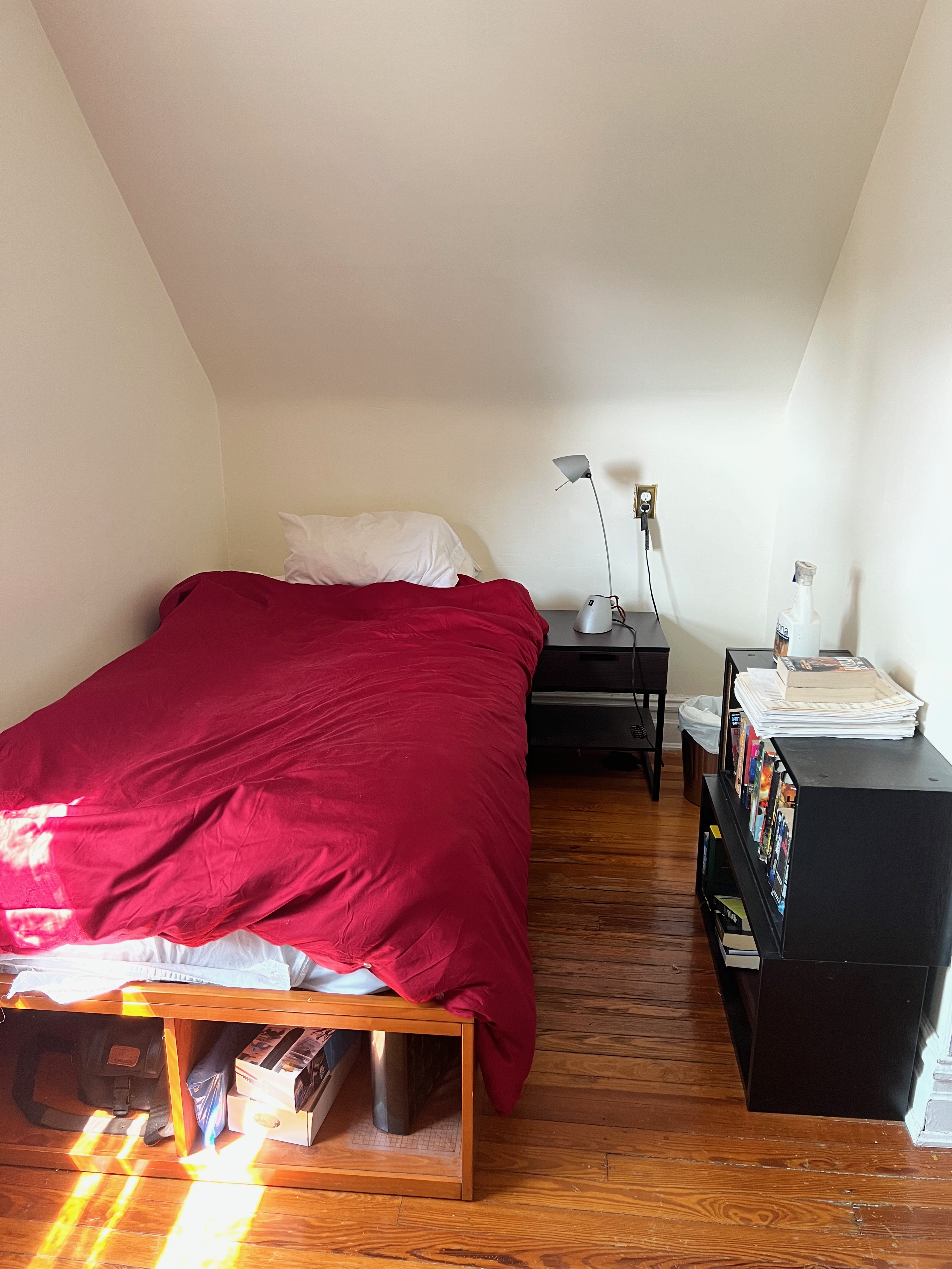 630 East 24th Street Brooklyn, NY 11210 - Photo 24 of 28 a bedroom with a bed and a night stand