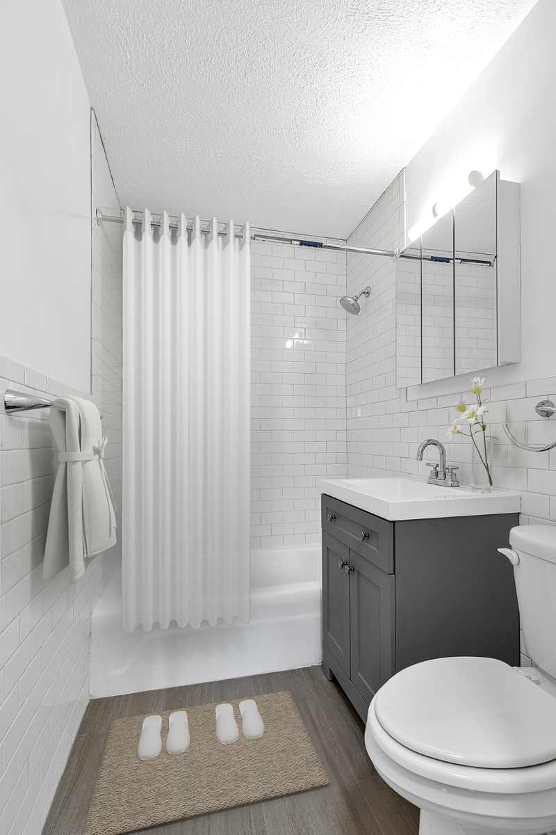 3333 Broadway, Unit E4C Manhattan, NY 10031 - Photo 8 of 23 a bathroom with a sink a toilet and shower