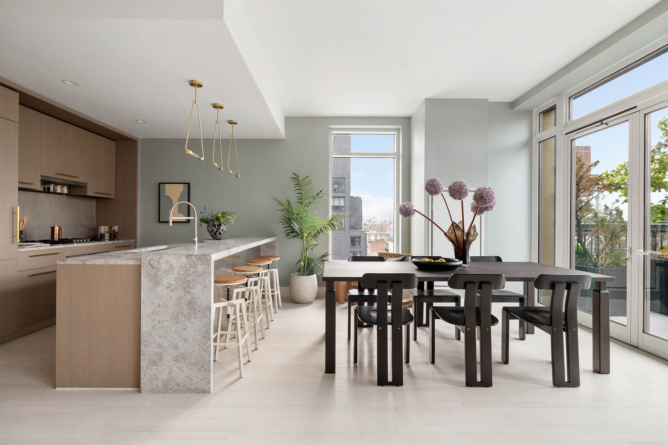 91 Leonard Street, Unit 14A Manhattan, NY 10013 - Photo 5 of 27 a kitchen with kitchen island granite countertop a table chairs sink and cabinets