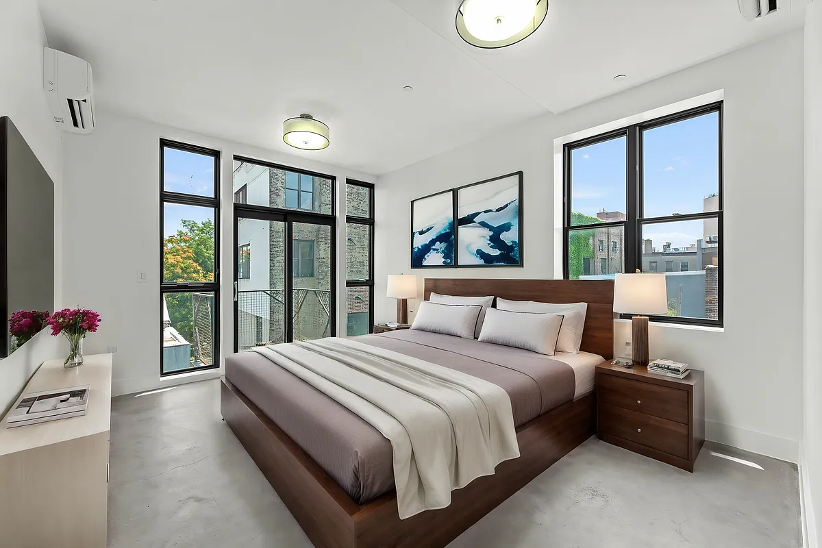 30 Belvidere Street, Unit PH4 Brooklyn, NY 11206 - Photo 4 of 8 a bedroom with a large bed and a large window