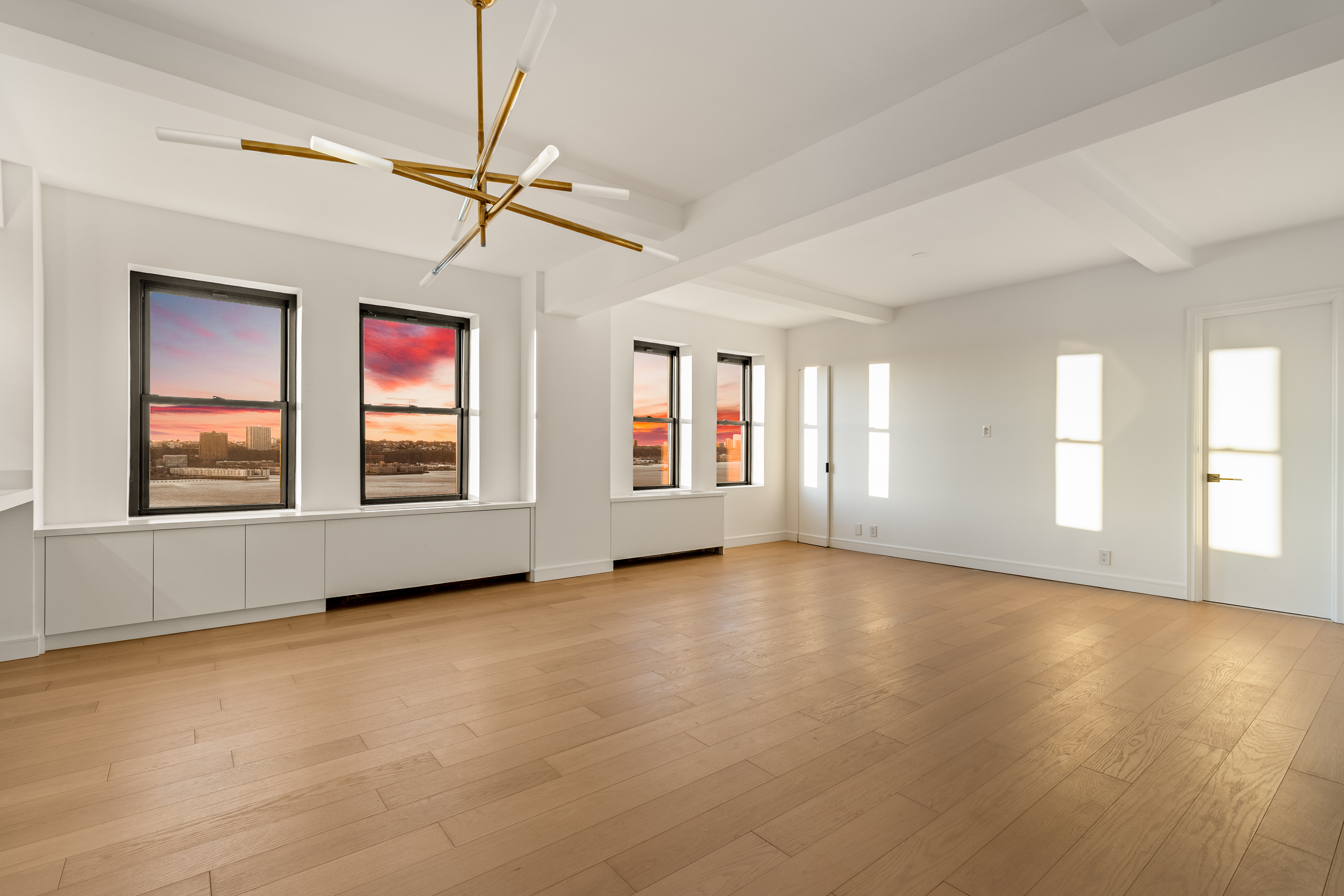 230 Riverside Drive, Unit 14AC Manhattan, NY 10025 - Photo 21 of 30 a view of an empty room with window and wooden floor