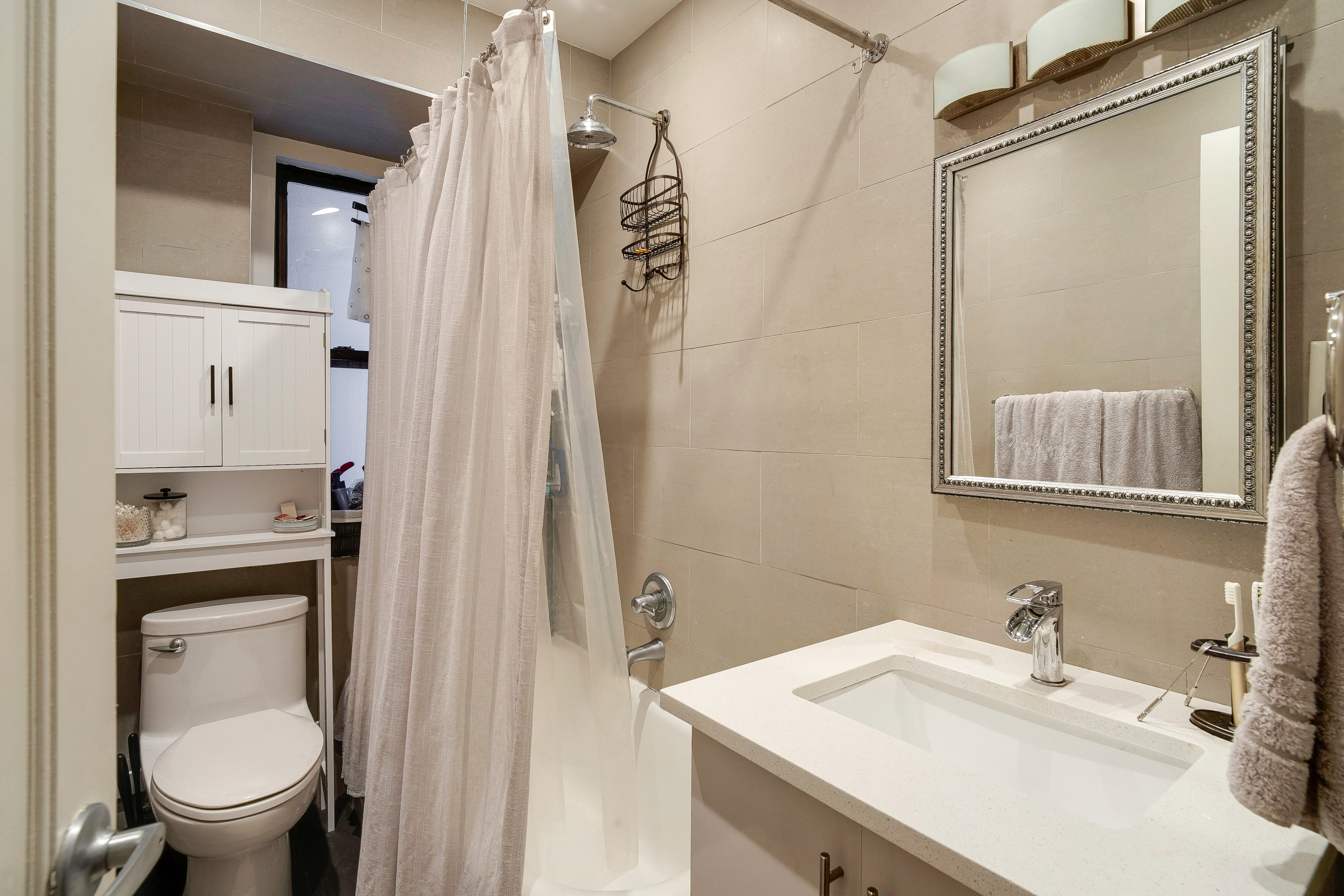 114 West 70th Street Manhattan, NY 10023 - Photo 4 of 9 a bathroom with a sink a toilet and shower