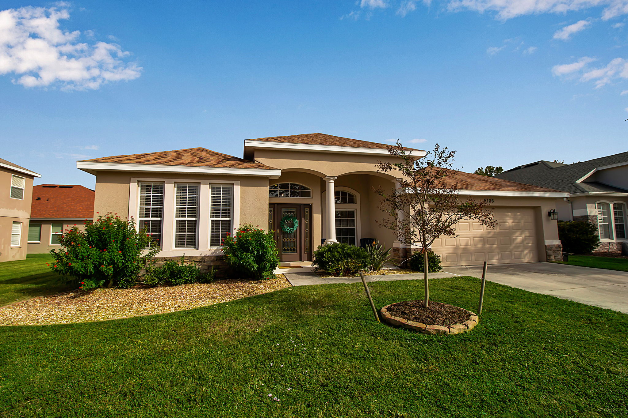 6106 34th Court East Bradenton, FL 34203 - Photo 10 of 69 a front view of a house with a yard fire pit and outdoor seating