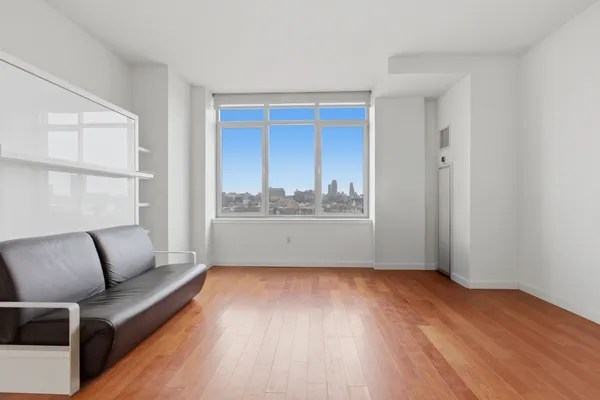 a view of room with furniture and wooden floor