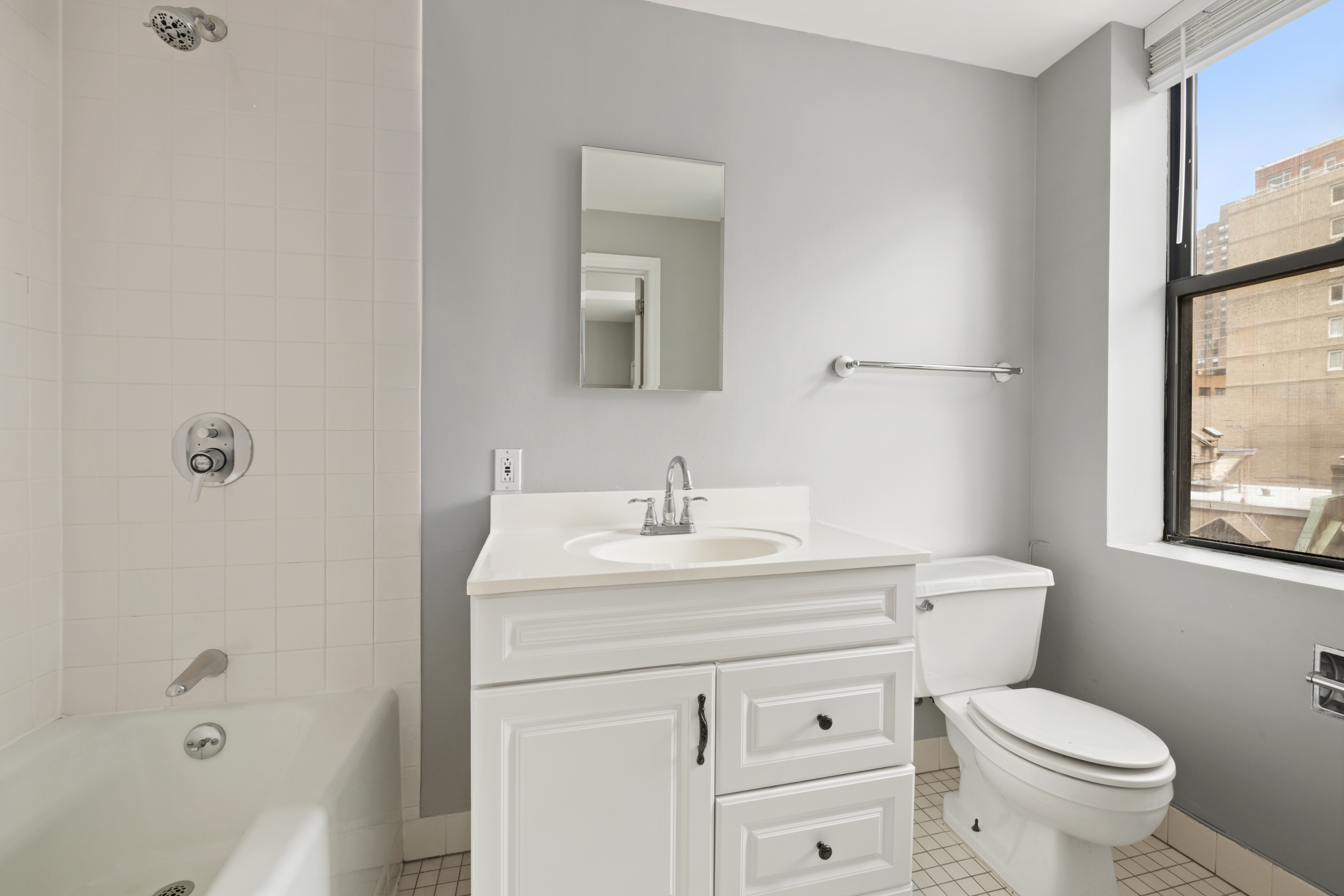 545 West End Avenue, Unit 7C Manhattan, NY 10024 - Photo 9 of 11 a bathroom with a sink toilet vanity and bathtub