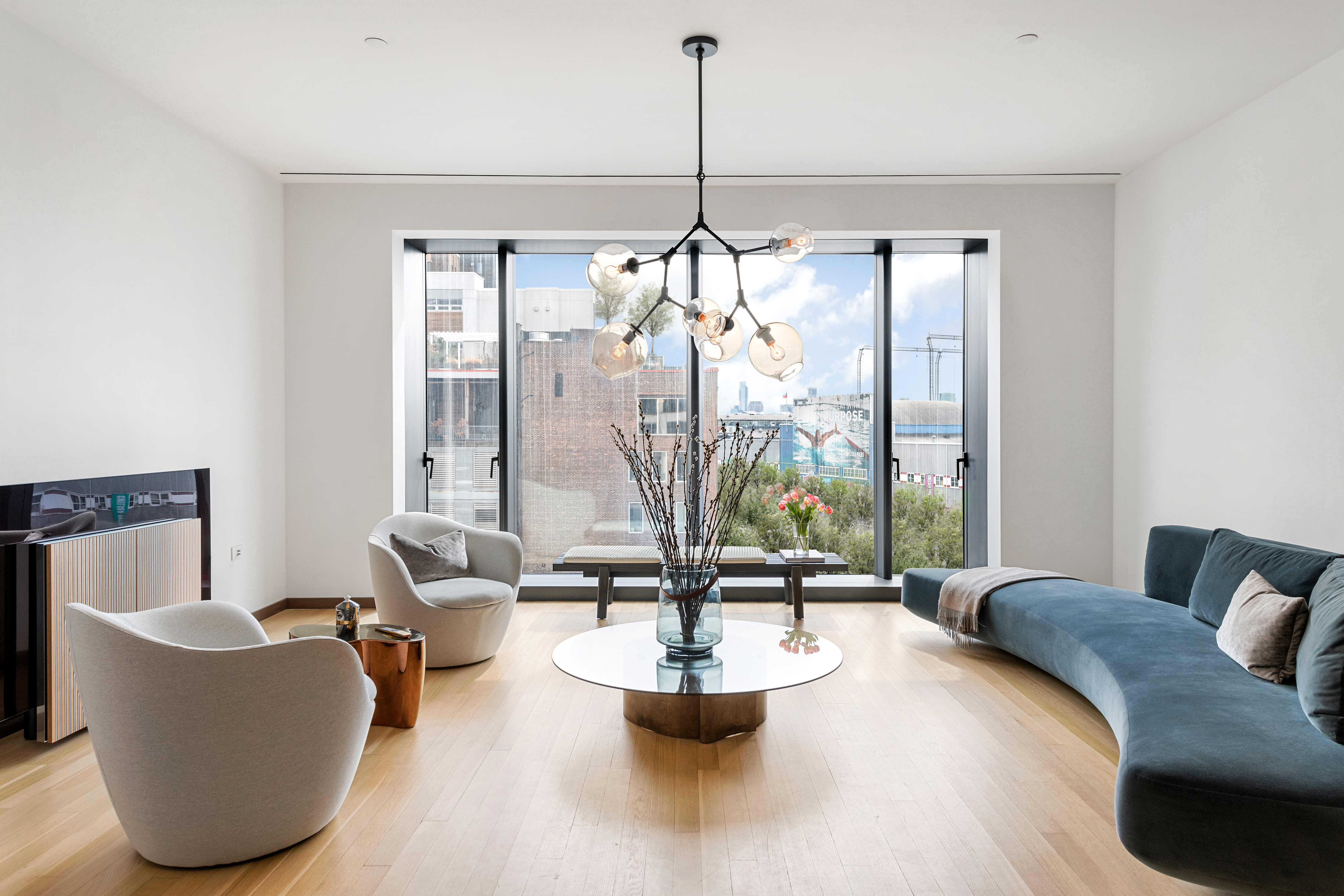 551 West 21st Street, Unit 4D Manhattan, NY 10011 - Photo 1 of 16 a living room with couches and a coffee table