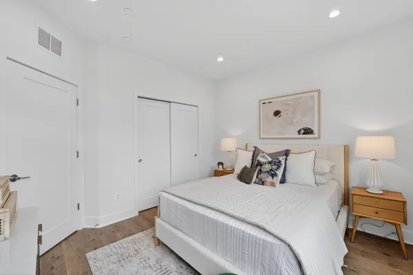 a bedroom with a bed and a night stand