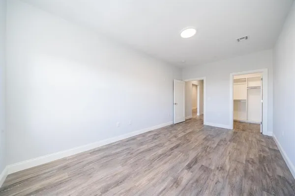 a view of an empty room and wooden floor