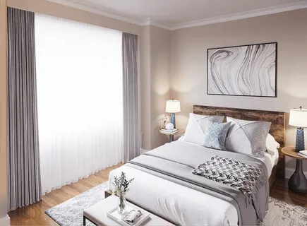 a bedroom with a large bed and a wooden floor