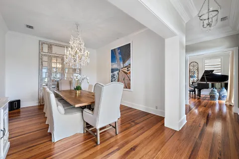 a view of a dining room with furniture wooden floor and chandelier