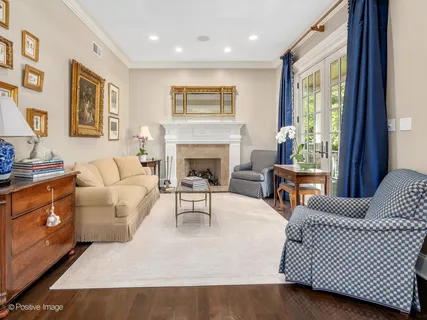 a kitchen with stainless steel appliances granite countertop a table chairs sink and window