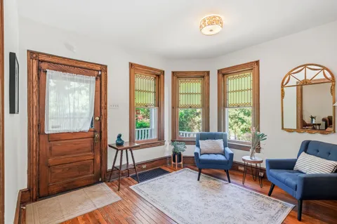 a living room with furniture or stairs and a wooden floor