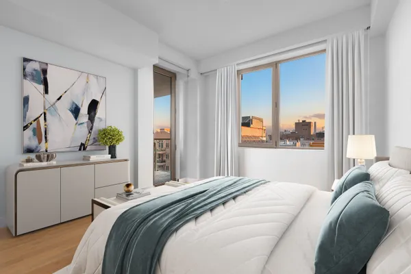a bedroom with a large bed and a painting on the wall