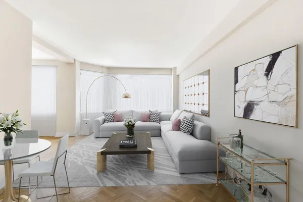 a living room with furniture and a potted plant