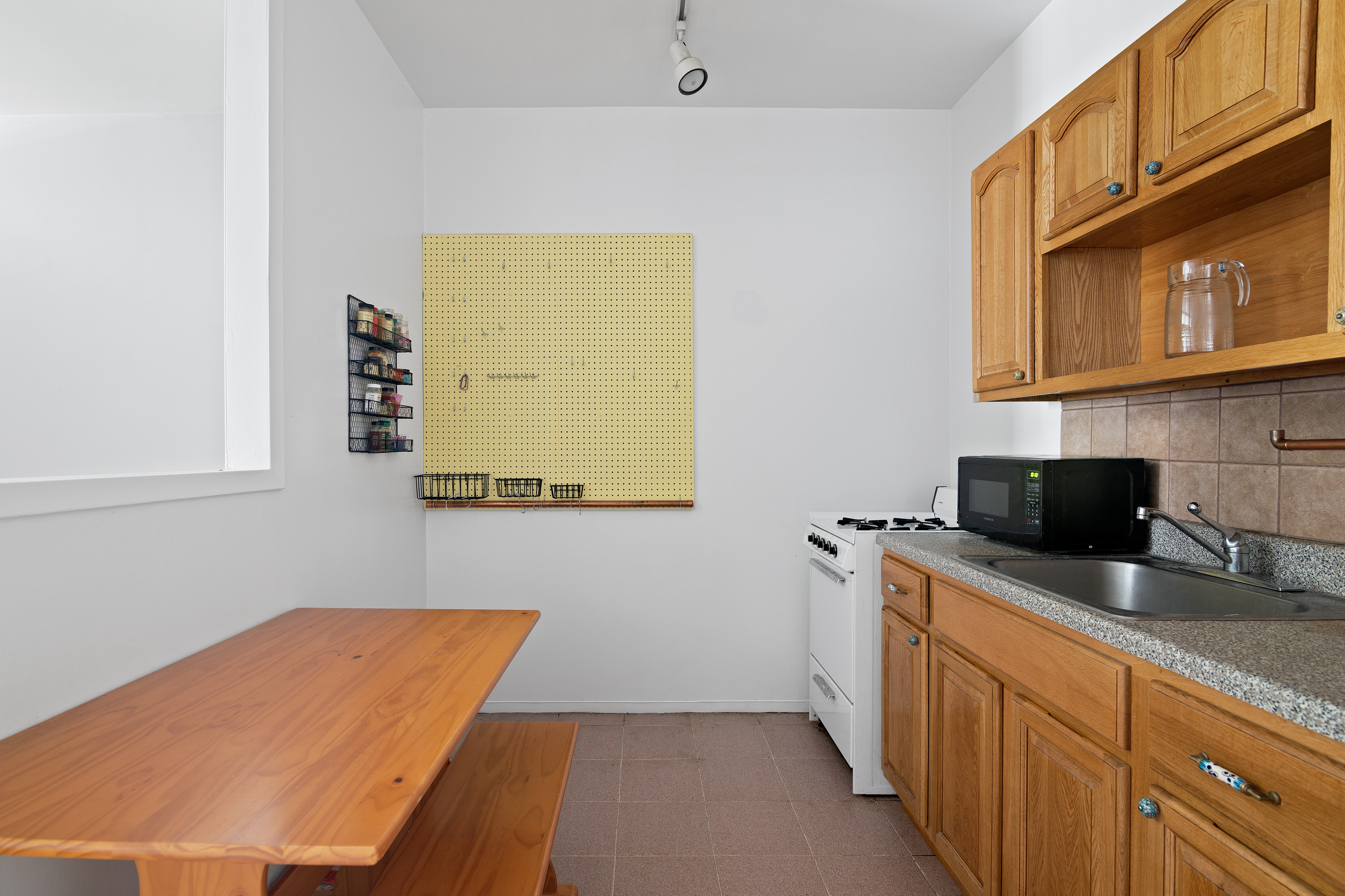 361 3rd Avenue, Unit 1 Manhattan, NY 10016 - Photo 4 of 7 a kitchen with a sink a stove and a microwave