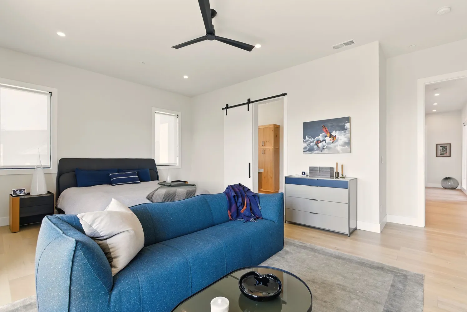 a living room with furniture and a floor to ceiling window