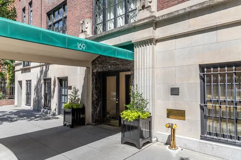 a front view of a building with glass top table and chairs