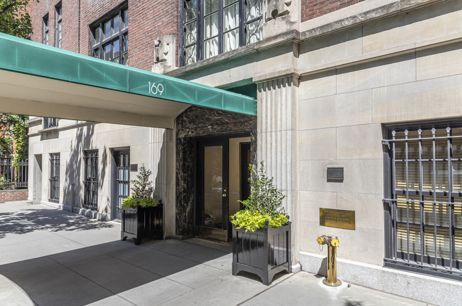 169 East 78th Street, Unit 5D Manhattan, NY 10075 - Photo 13 of 15 a front view of a building with glass top table and chairs