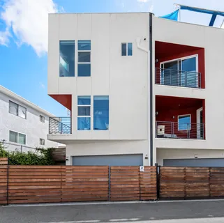 a front view of a house with garage and parking