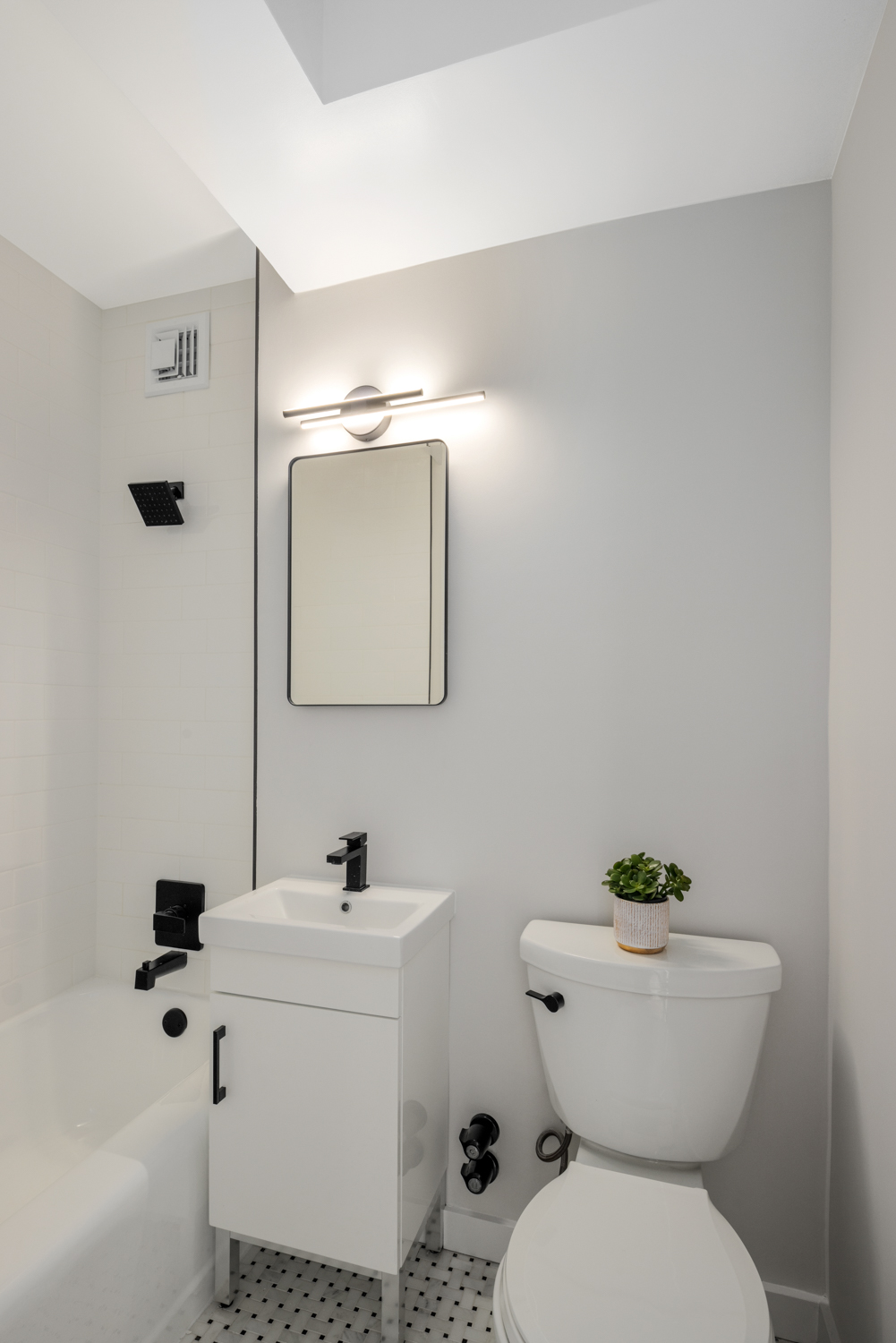 99-72 66th Road, Unit 3R Queens, NY 11374 - Photo 6 of 10 a bathroom with a toilet sink and mirror