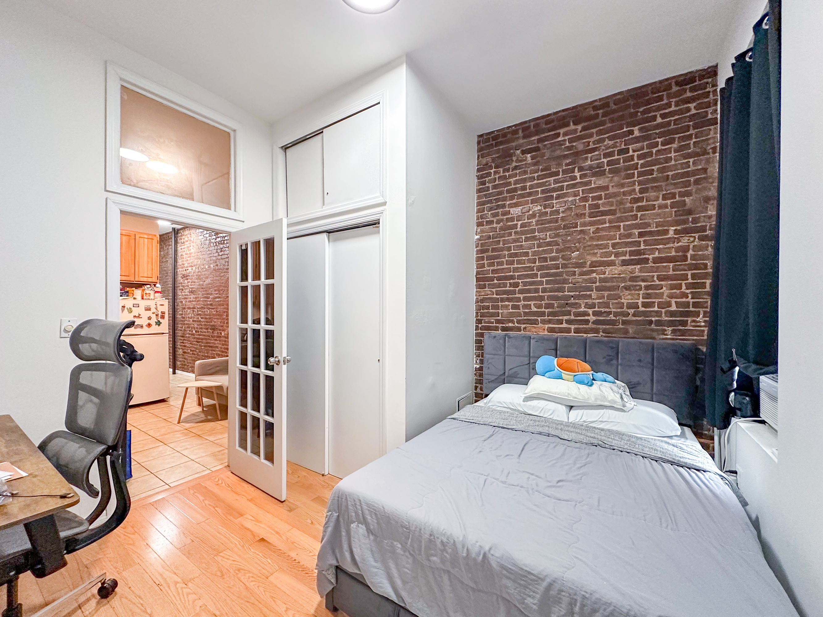 213 East 5th Street, Unit 1 Manhattan, NY 10003 - Photo 10 of 18 a bedroom with a bed and wooden floor