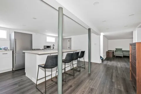 a view of kitchen with furniture and wooden floor