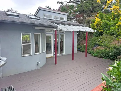 a patio with a table and chairs under an umbrella
