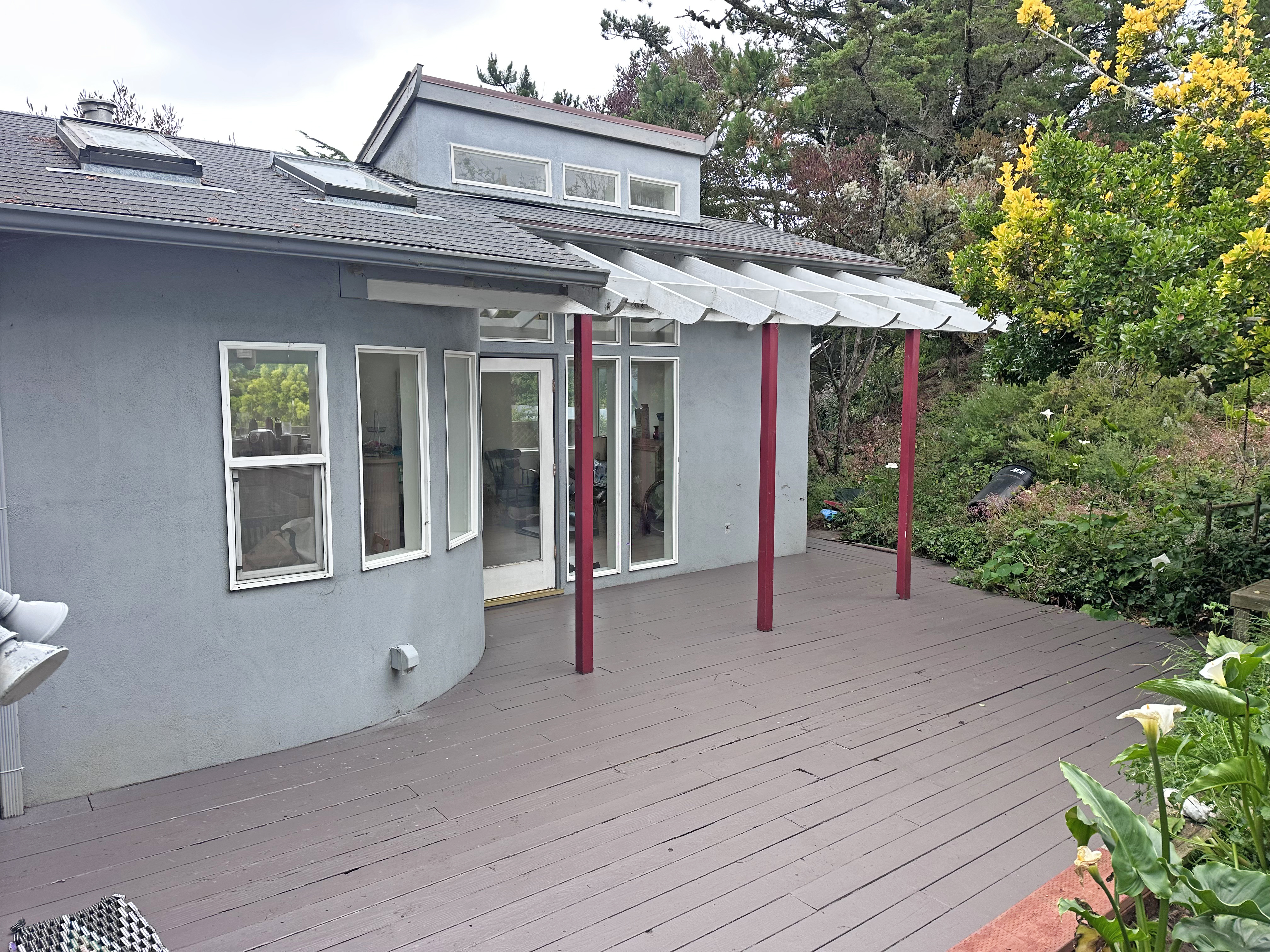 371 Inverness Drive Pacifica, CA 94044 - Photo 10 of 15 a patio with a table and chairs under an umbrella