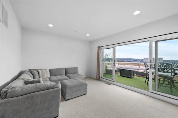 a living room with furniture and a floor to ceiling window