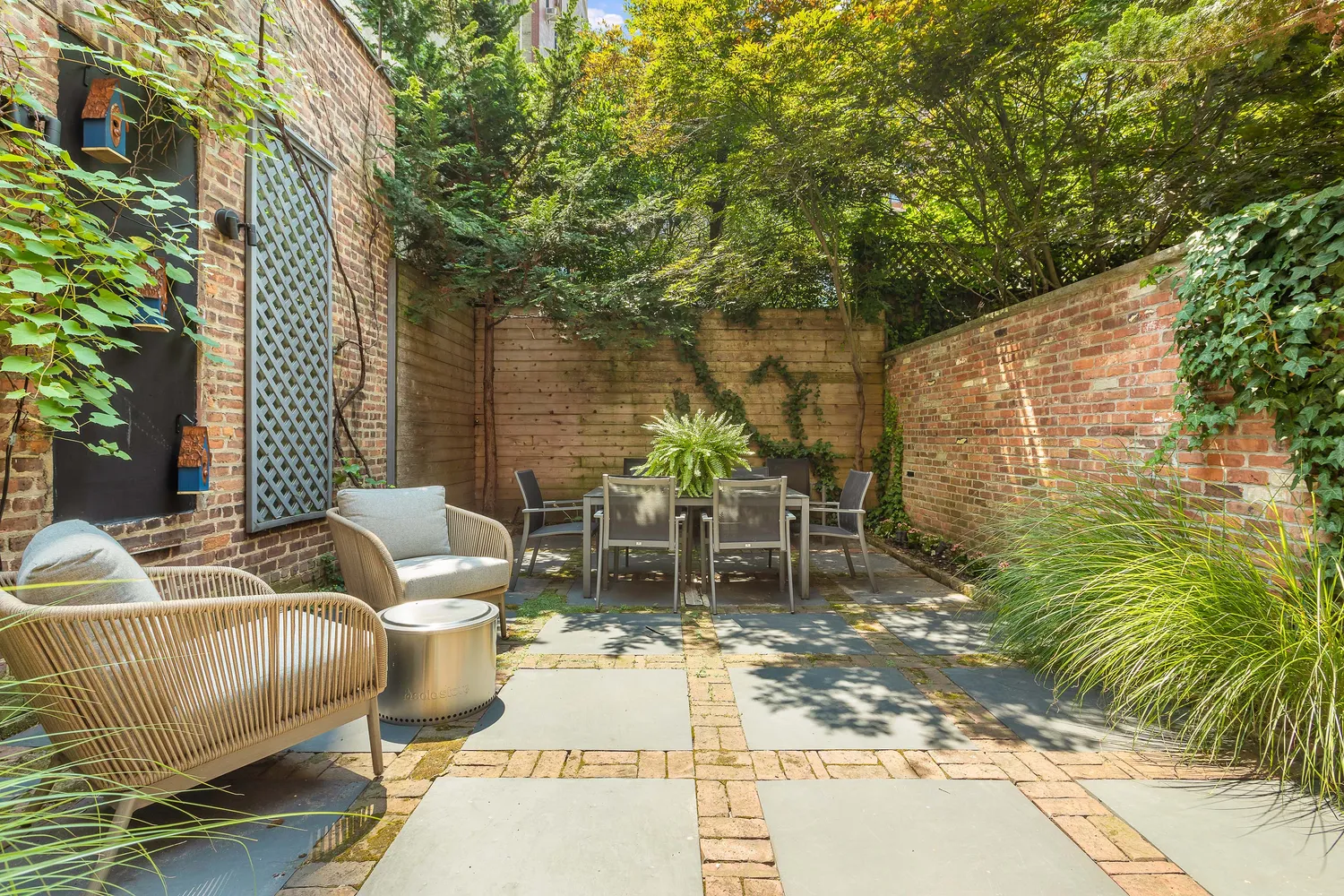 a view of a patio with couches table and chairs and potted plants