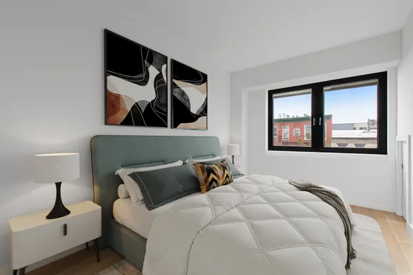 a bedroom with a bed and lamp