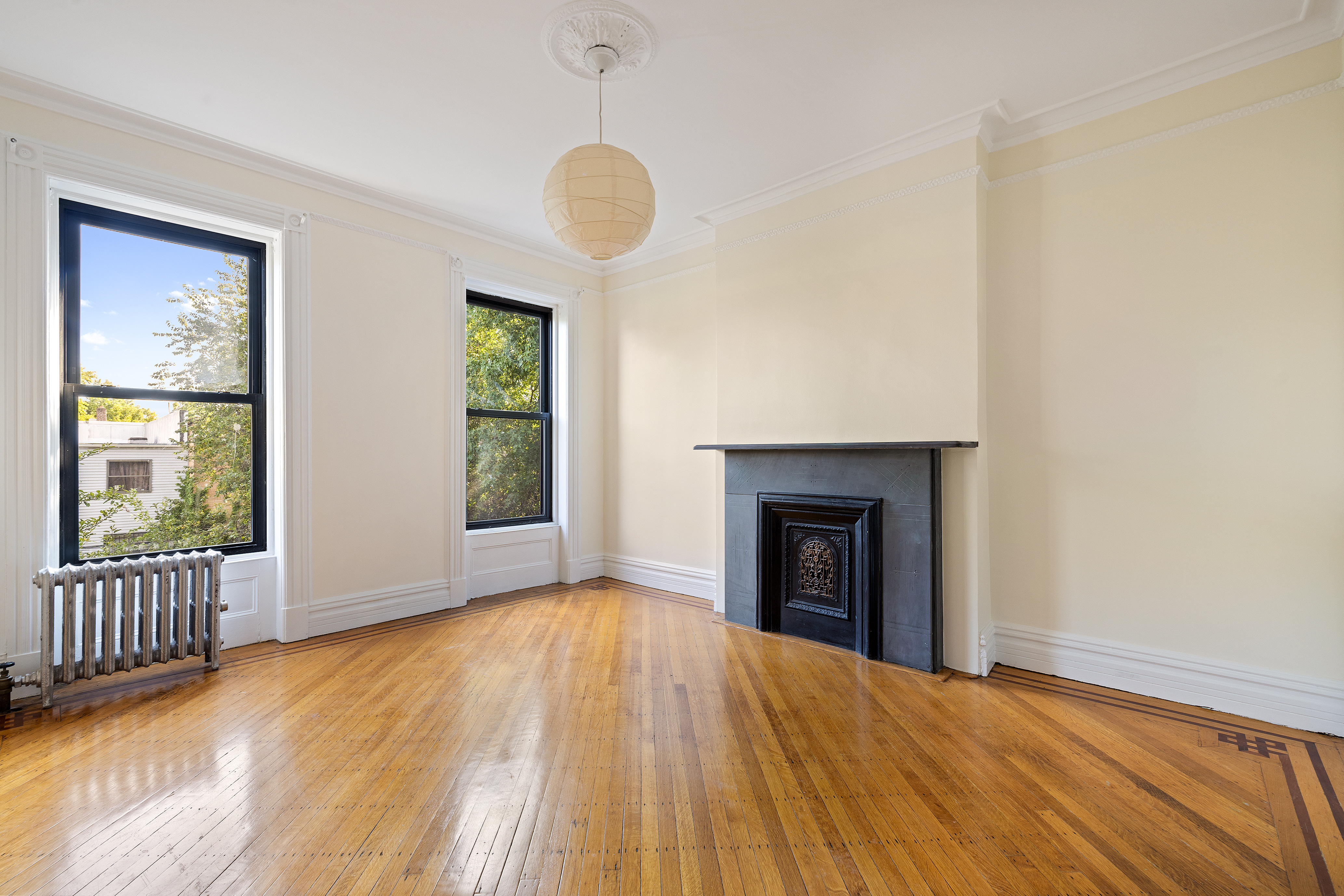778 Quincy Street, Unit 2 Brooklyn, NY 11221 - Photo 7 of 14 a view of an empty room with window and wooden floor