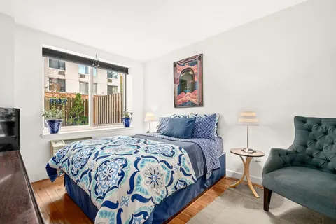 a bedroom with a bed and a couch