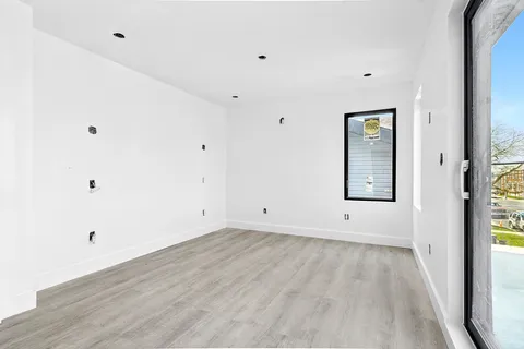 a view of room with window and hardwood floor