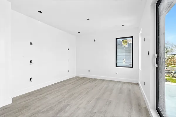 a view of room with window and hardwood floor