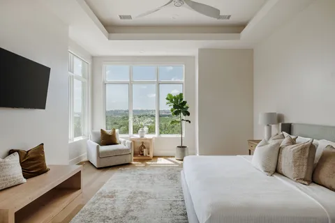 a bedroom with a bed and flat screen tv