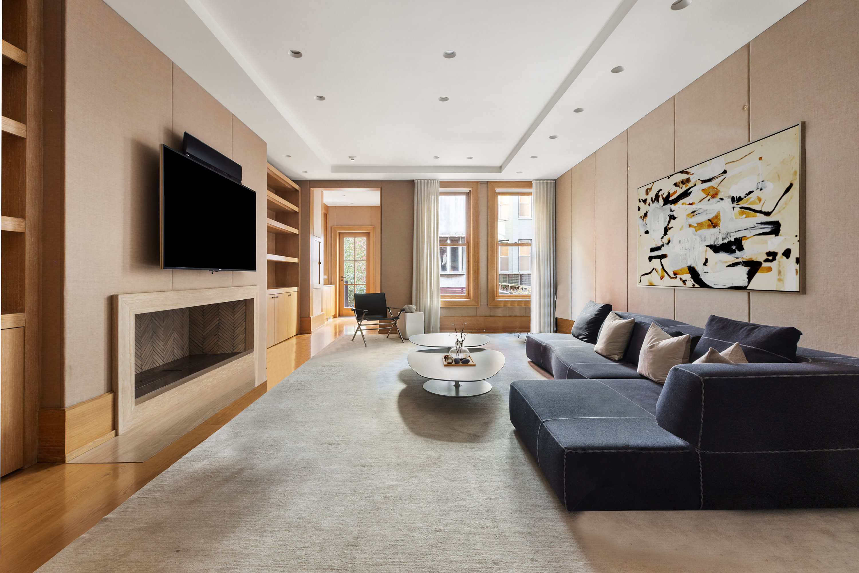 45 East 74th Street Manhattan, NY 10021 - Photo 6 of 33 a living room with fireplace furniture and a flat screen tv