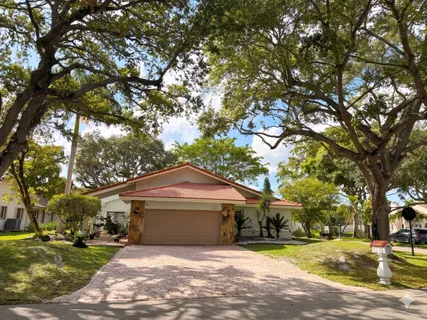 a front view of a house with a yard garage and outdoor seating
