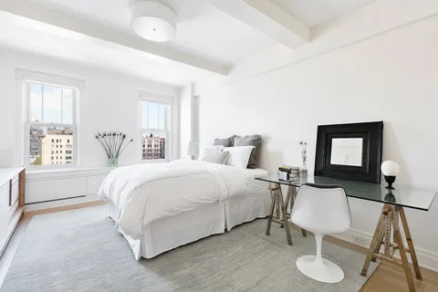 a bedroom with a bed and window