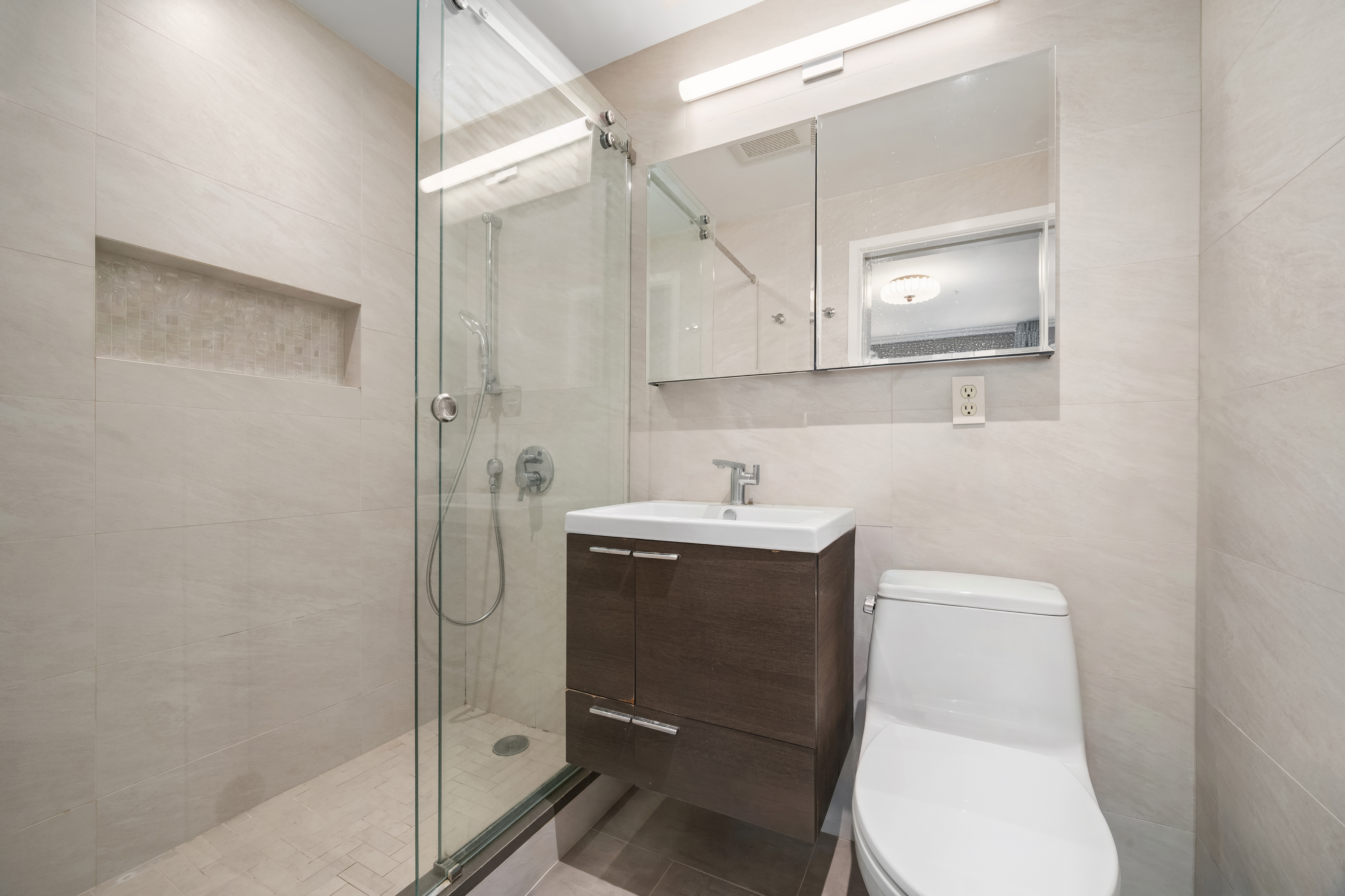 407 East 12th Street, Unit 3FE Manhattan, NY 10009 - Photo 7 of 11 a bathroom with a sink toilet and shower