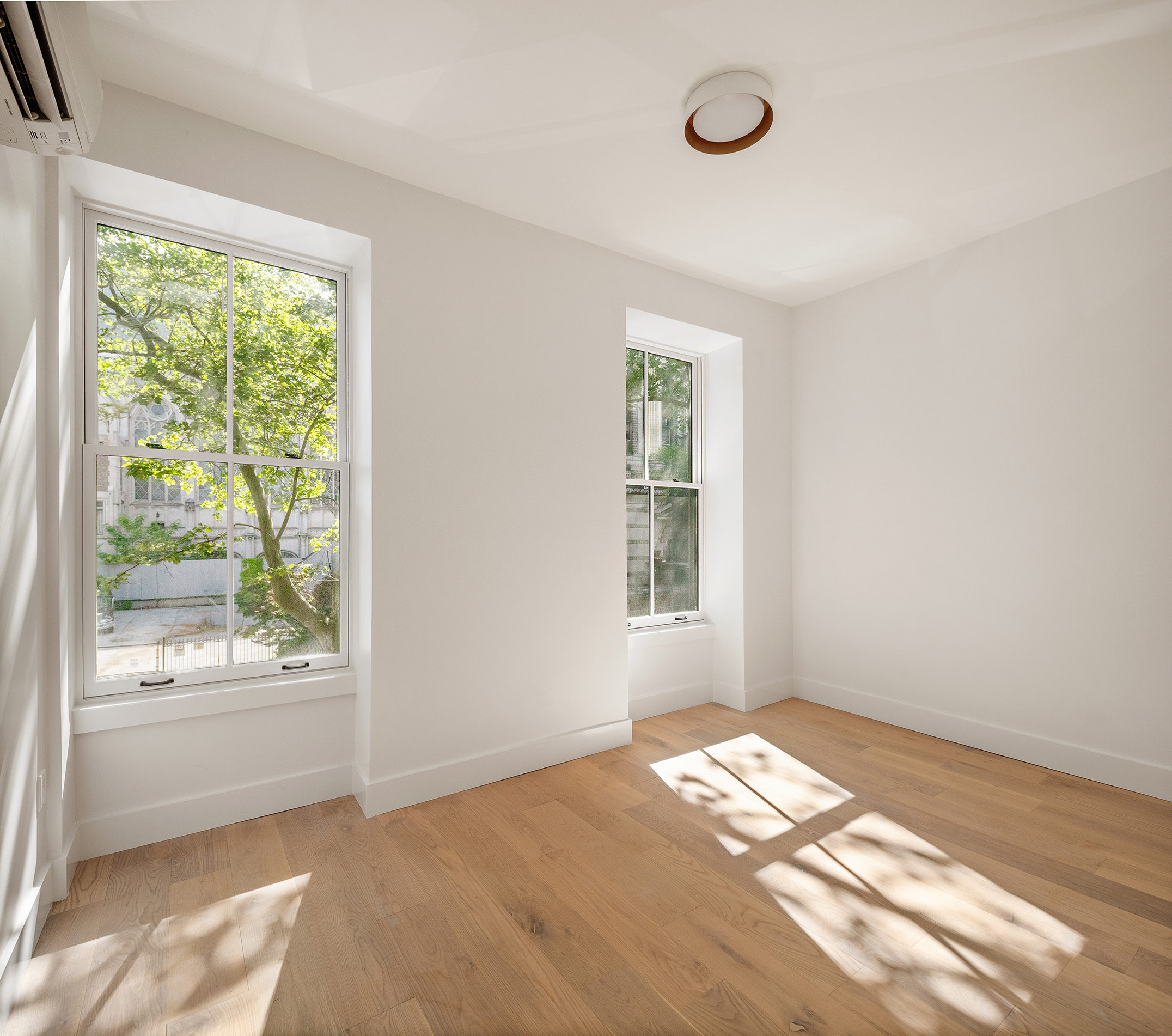 324 Clermont Avenue, Unit 4 Brooklyn, NY 11205 - Photo 4 of 9 a view of empty room with window and wooden floor
