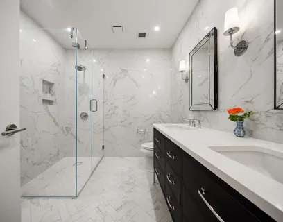a bathroom with a double vanity sink mirror and shower