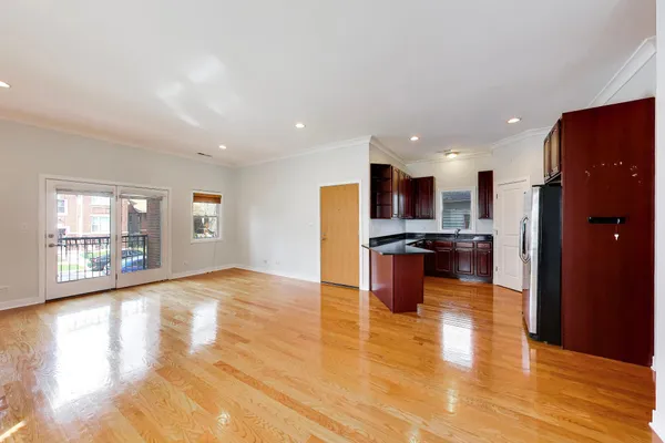 a view of kitchen with refrigerator and wooden floor